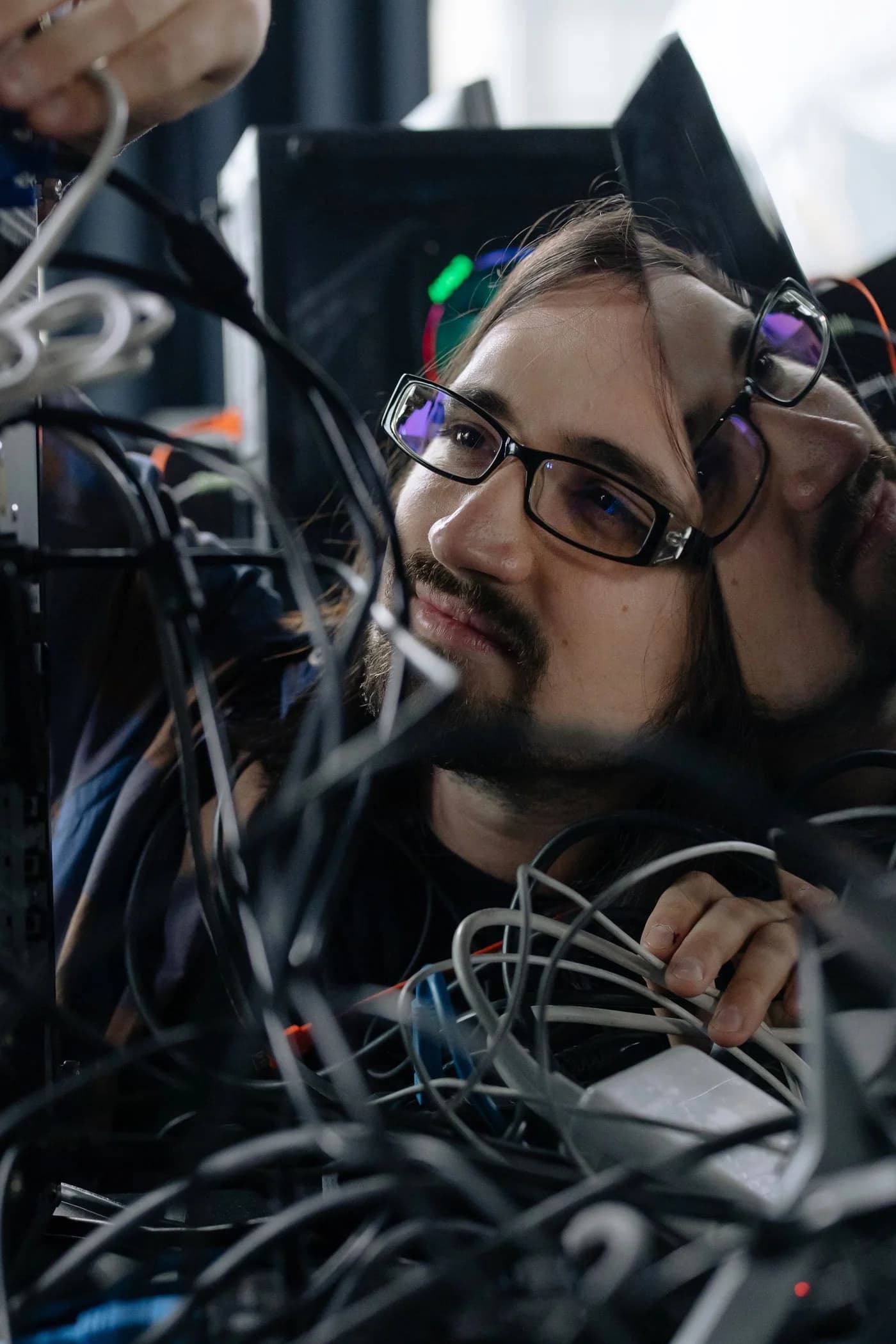 A technician connecting network cables.